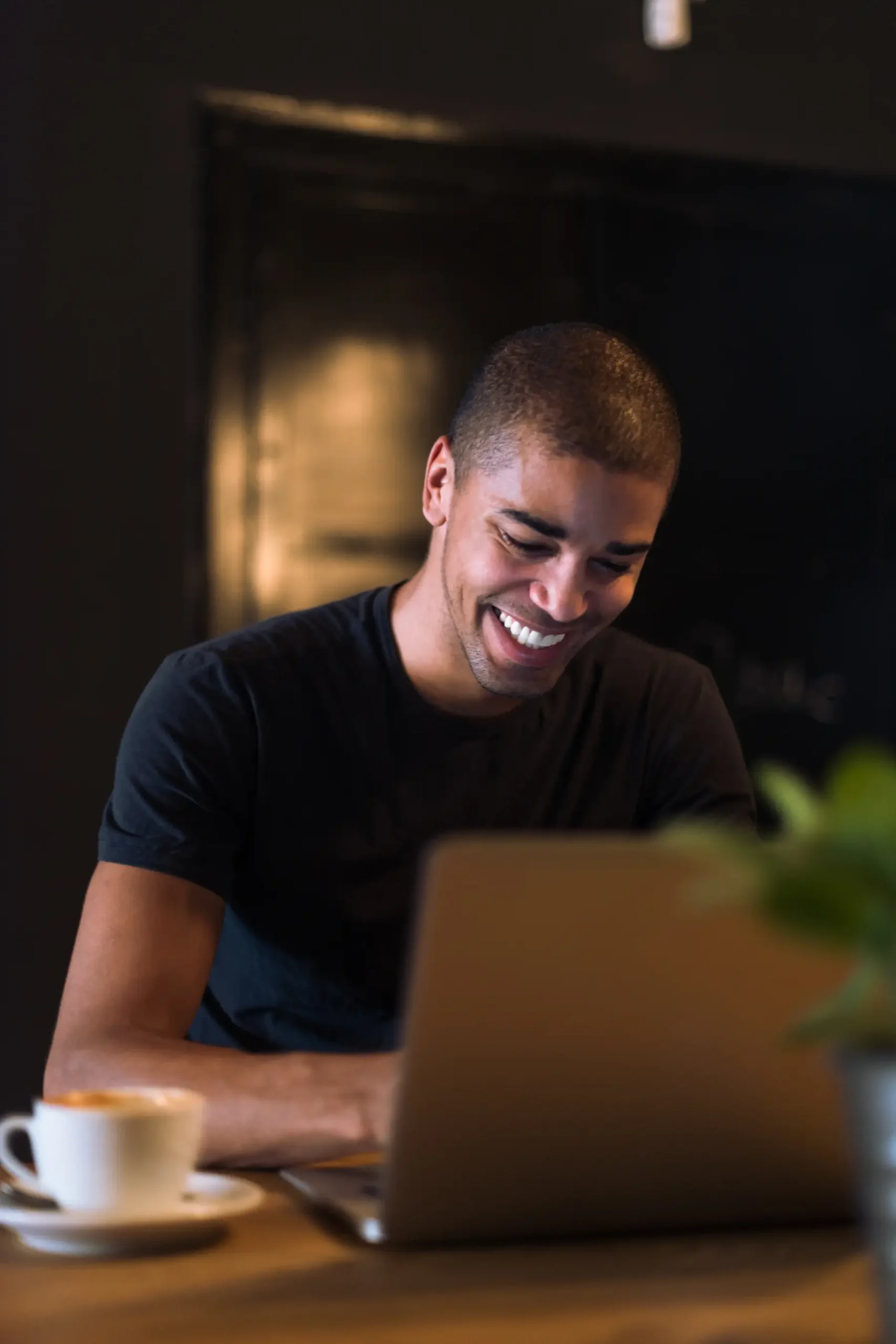 Man Smiling with a laptop